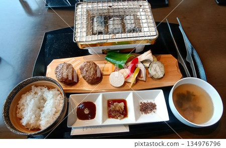 Charcoal grilled hamburger steak set meal served with local vegetables Charcoal grilled hamburger steak set meal served with local vegetables 134976796