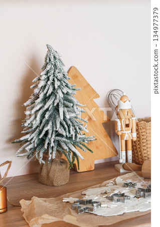Christmas tree, baking background with cookie cutters, rolling pin and festive kitchen decor Christmas tree, baking background with cookie cutters, rolling pin and festive kitchen decor 134977379