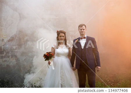 Young Bride And Groom Walking Through Smoke 134977406