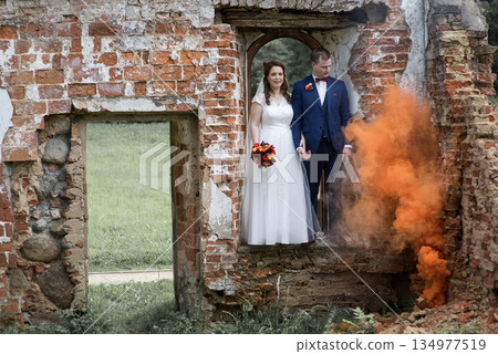 Wedding Couple With Expanding Orange Smoke Wedding Couple With Expanding Orange Smoke 134977519