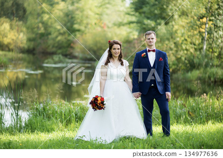 Young Bride And Groom Standing Together Portrait 134977636