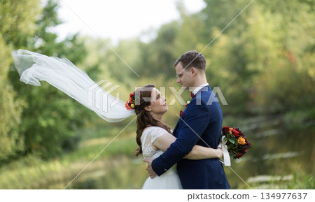 Young Wedding Couple Embracing With Veil Motion Young Wedding Couple Embracing With Veil Motion 134977637