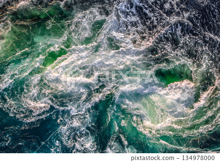 Blue waves of water of the river and the sea meet each other during high tide and low tide. Blue waves of water of the river and the sea meet each other during high tide and low tide. 134978000