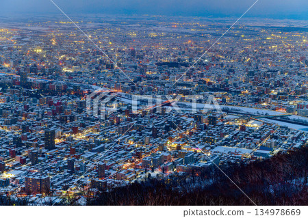 Night view of Sapporo cityscape in winter at twilight from Mt. Moiwa observation, the best city view point, Sapporo, Hokkaido, Japan Night view of Sapporo cityscape in winter at twilight from Mt. Moiwa observation, the best city view point, Sapporo, Hokkaido, Japan 134978669