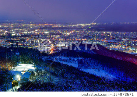 Night view of Sapporo cityscape in winter at twilight from Mt. Moiwa observation, the best city view point, Sapporo, Hokkaido, Japan Night view of Sapporo cityscape in winter at twilight from Mt. Moiwa observation, the best city view point, Sapporo, Hokkaido, Japan 134978671