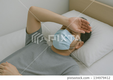 室內照片，畫面中一個人感到身體不適，躺了下來。 134979412