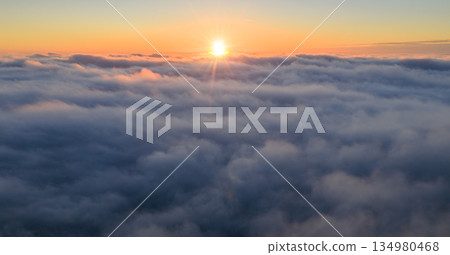 Golden sunrise above a sea of clouds, creating a calm and dreamy atmosphere. Warm morning light illuminates soft cloud layers, evoking freedom, serenity, and a sense of endless space. Golden sunrise above a sea of clouds, creating a calm and dreamy atmosphere. Warm morning light illuminates soft cloud layers, evoking freedom, serenity, and a sense of endless space. 134980468