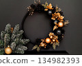 Sleek modern wreath in matte black and gold for stylish holiday decor 134982393