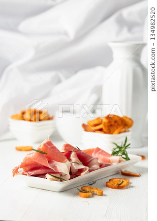 Prosciutto with rosemary and spicy bruschetta crackers. Prosciutto with rosemary and spicy bruschetta crackers. 134982520