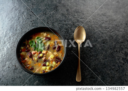 Red bean soup with potatoes, tomatoes, paprika, carrot, and bacon. 134982557