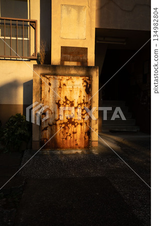 Garbage collection area of an old apartment building, dust chute door 134982804
