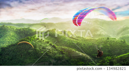 Paragliding multicolor. Paraglider flying over Landscape from the background Beauty nature mountain landscape of the sky. 134982821