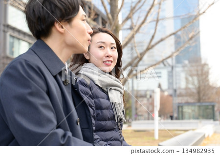 Men and women having a conversation in an office district Men and women having a conversation in an office district 134982935