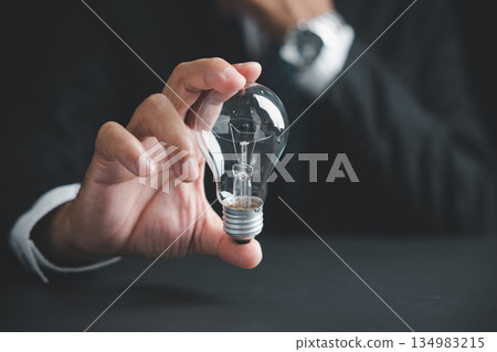 A closeup of a man hand making a pose, this sign gesture presents a light bulb as a good sign for a creative new idea, innovation, and finding a successful solution. 134983215
