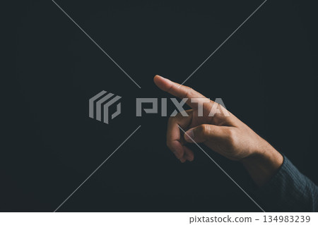 Hand pointing right, isolated on black background. Minimalist design concept. .. Hand pointing right, isolated on black background. Minimalist design concept. .. 134983239