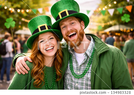Happy young couple in green hats celebrating St. Patrick's Day at an outdoor festival, festive mood.  134983328