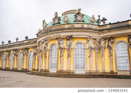 Sanssouci Palace of King Frederick II in Potsdam, Germany. Old building architecture in Rococo style. Yellow facade wall and windows 134983341