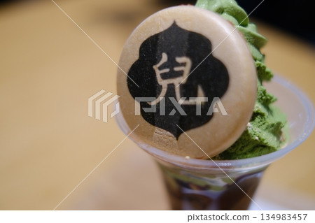Monaka wafers and matcha soft serve ice cream featuring the Ukita family crest Monaka wafers and matcha soft serve ice cream featuring the Ukita family crest 134983457