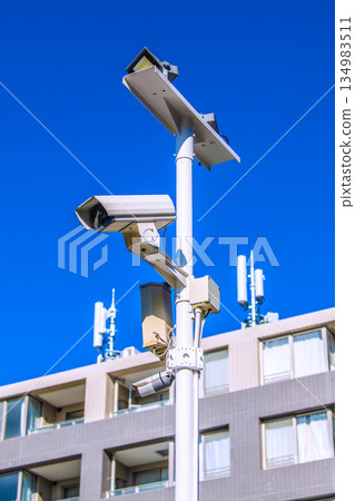 Yokohama cityscape in Japan: Security cameras on street corners. Looking forward to security cameras shining against the blue sky... a new era - Yokohama city 134983511