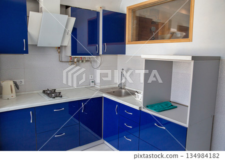 Modern blue kitchen interior with white countertop. 134984182