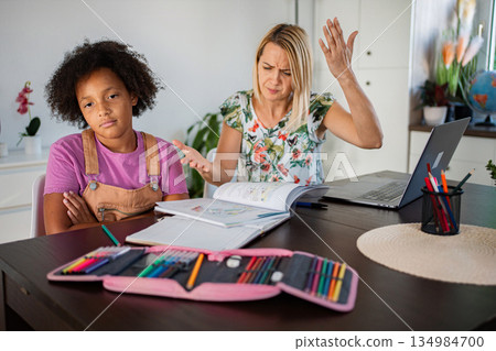 Frustrated mother arguing with bored daughter during homework time Frustrated mother arguing with bored daughter during homework time 134984700