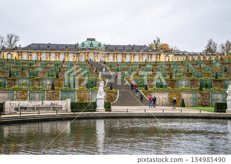Sanssouci park in Potsdam, Germany. Old garden stairs building architecture in Rococo style. Nature outdoor landscape Sanssouci park in Potsdam, Germany. Old garden stairs building architecture in Rococo style. Nature outdoor landscape 134985490