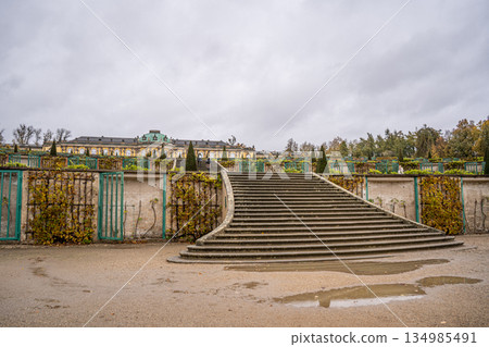 Sanssouci Palace of King Frederick II in Potsdam, Germany. Old building architecture in Rococo style. Yellow facade and garden stairs 134985491