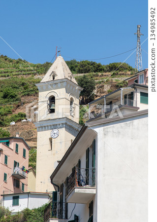 Tower bell church. Italian windows balcony of multicolored house. Summer in Cinque Terre Italy 134985492