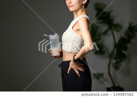 Woman drinking protein Woman drinking protein 134985562