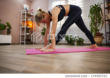 Yoga practice enhances flexibility in serene indoor space 134985583