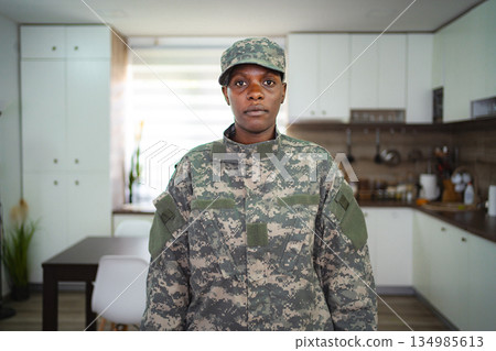 Confident female soldier standing in kitchen 134985613