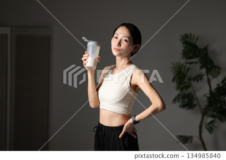 Woman drinking protein Woman drinking protein 134985840
