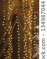 Abstract Christmas background with radiant golden bokeh lights creating a festive, warm holiday decoration concept for banner. 134987044