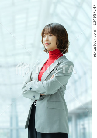 Smiling woman with folded arms, businesswoman Smiling woman with folded arms, businesswoman 134987147