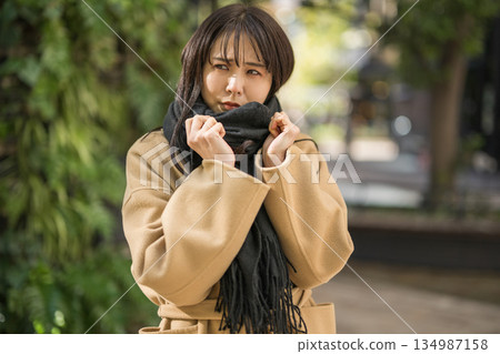 寒冷的冬天,一位女士圍著圍巾 寒冷的冬天,一位女士圍著圍巾 134987158
