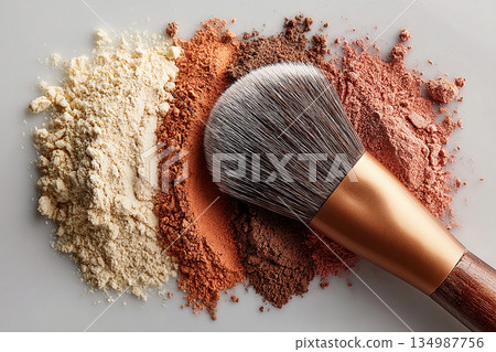 Universally flattering. Flat lay of makeup brush placed next to a color palette on white background. Universally flattering. Flat lay of makeup brush placed next to a color palette on white background. 134987756
