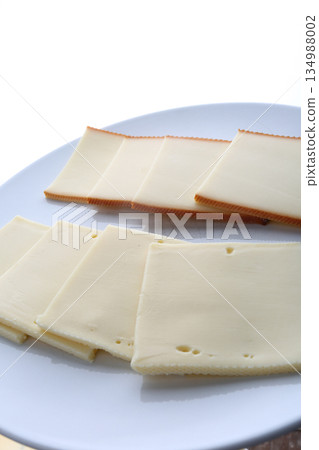 sliced cheese pieces for a traditional raclette lunch sliced cheese pieces for a traditional raclette lunch 134988002