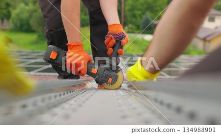 Slow motion of construction worker cutting steel beam. Man works circular saw. Flies of spark from hot metal. Man worked over the steel. close-up of hand and electric saws metal. Close-up of hand too. 134988901