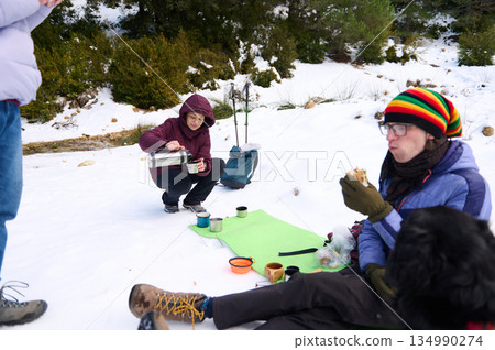 Snowy Outdoor Break With Friends: Coffee, Snacks, And Cold Winter Adventure In The Forest 134990274
