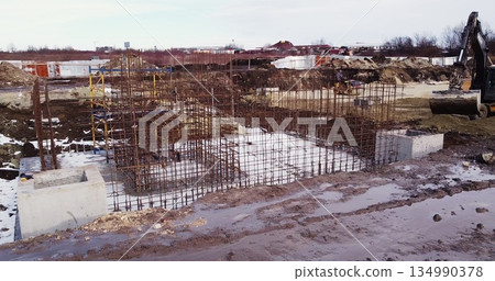 Building workers are constructing a metal framework. Workers working on the construction site removed from the drone. Builders build a house. View from the quadcopter. 134990378