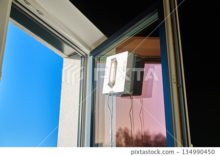 Window cleaning robot on glass surface 134990450