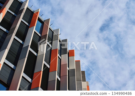 Modern office building with curved geometric facade 134990486