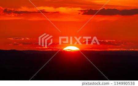 Beautiful panoramic red and orange sunset over the silhouetted Chiltern Hills in England 134990538