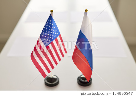 US and Russia mini desk flags showcasing diplomacy on conference negotiation table 134990547