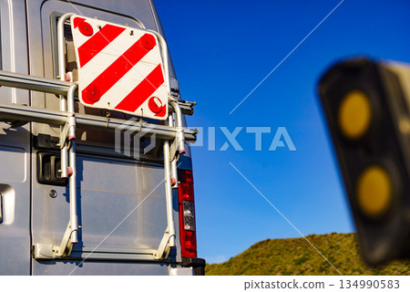 Car van with rack on back and rear warning sign for safety 134990583