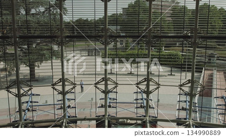 Handsomely dressed man goes to work in a large glass office. Businessman ode returns to the office. sunny day success slow motion. 134990889