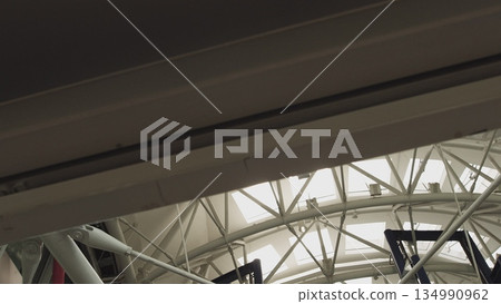 Modern architecture detail glass ceiling in the office building roof company architecture modern corporate department building business window interior industrial construction structure. Modern architecture detail glass ceiling in the office building roof company architecture modern corporate department building business window interior industrial construction structure. 134990962