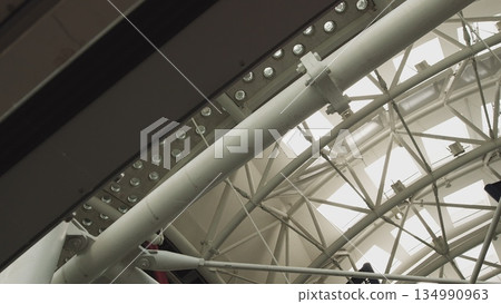 Modern architecture detail glass ceiling in the office building roof company architecture modern corporate department building business window interior industrial construction structure. Modern architecture detail glass ceiling in the office building roof company architecture modern corporate department building business window interior industrial construction structure. 134990963