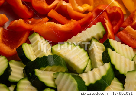Freshly cut zucchini and bell peppers creating vibrant culinary scene Freshly cut zucchini and bell peppers creating vibrant culinary scene 134991081