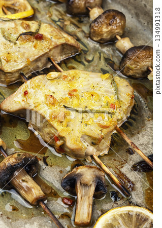 Baked tuna with mushrooms, kebabs. Baked tuna with mushrooms, kebabs. 134991318